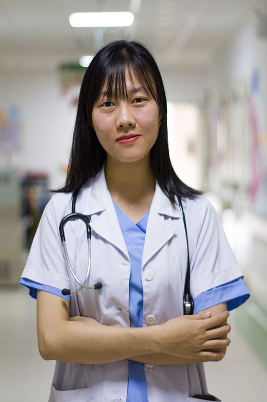 Young female medical student in white coat